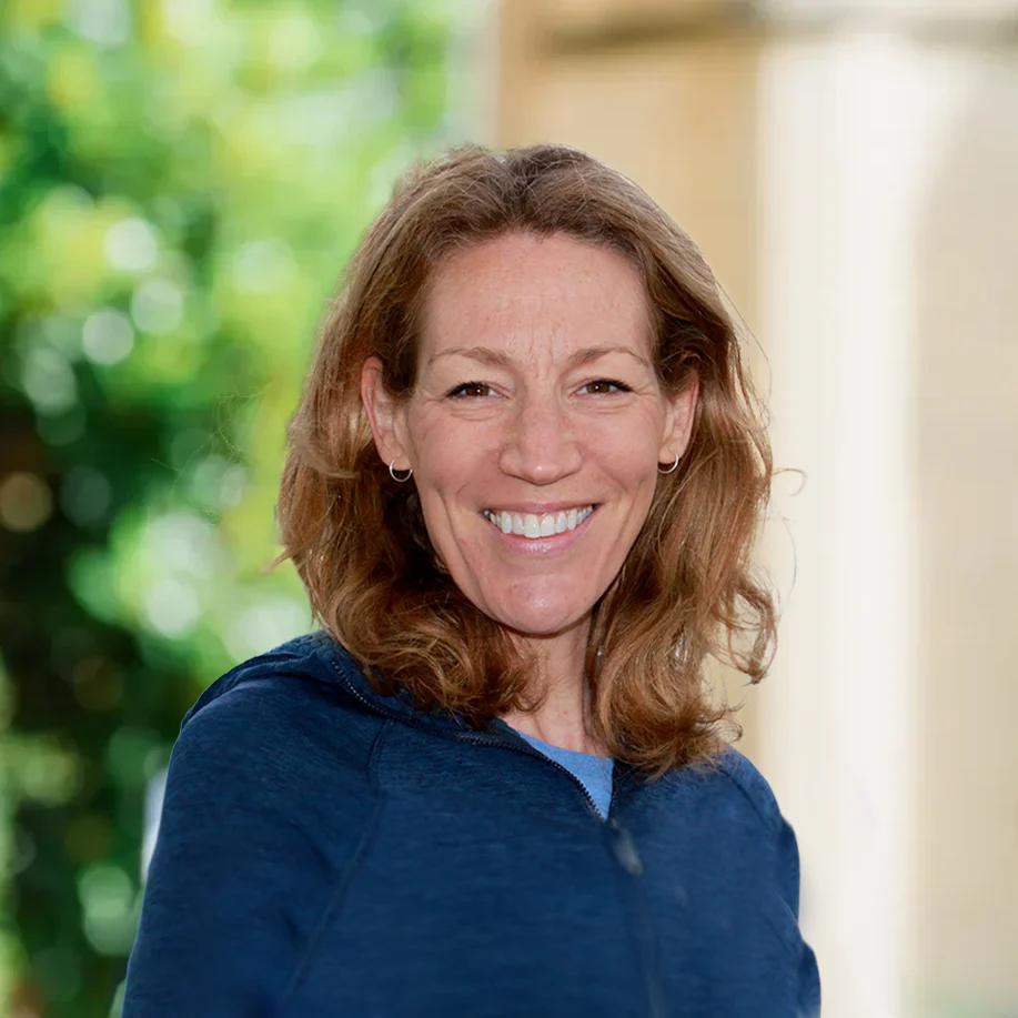Smiling woman outdoors in blue jacket