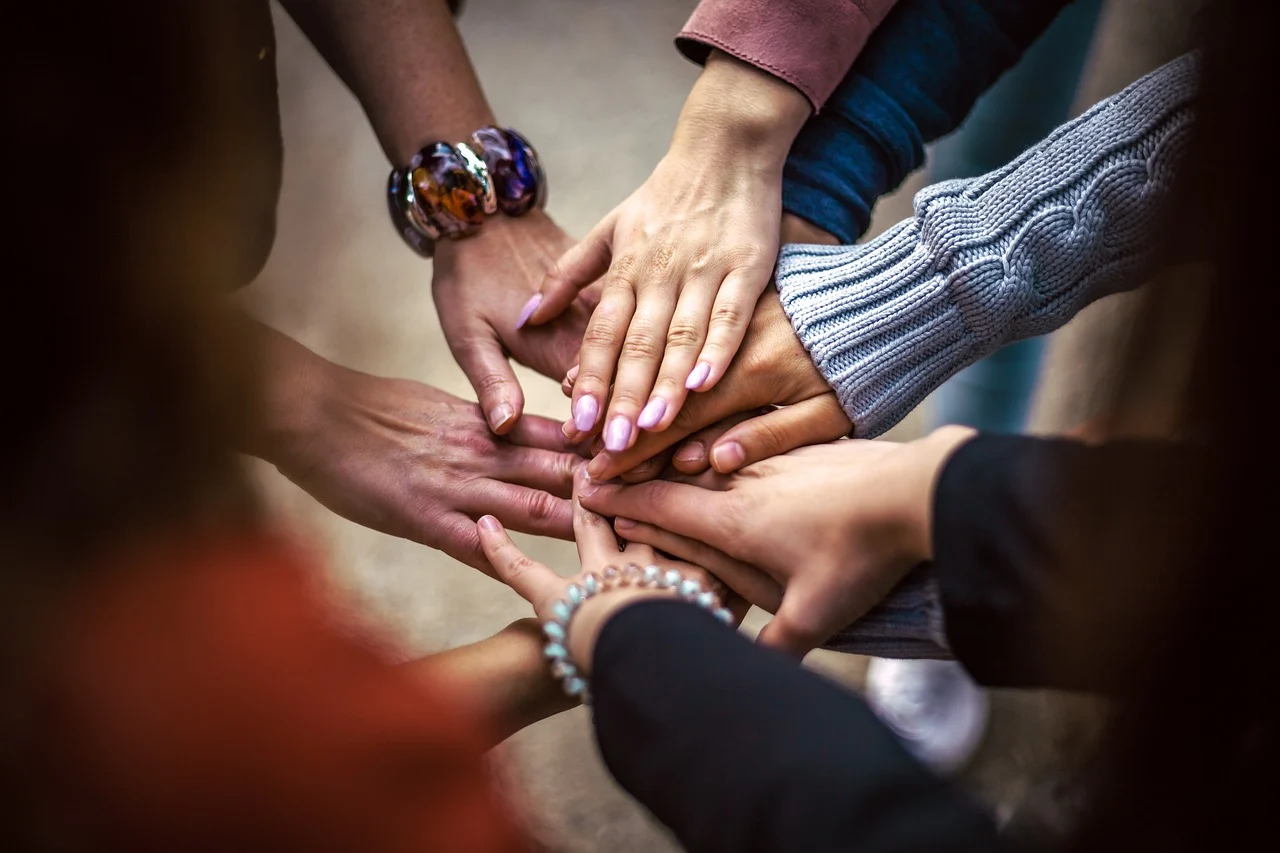 Group of hands stacked in unity