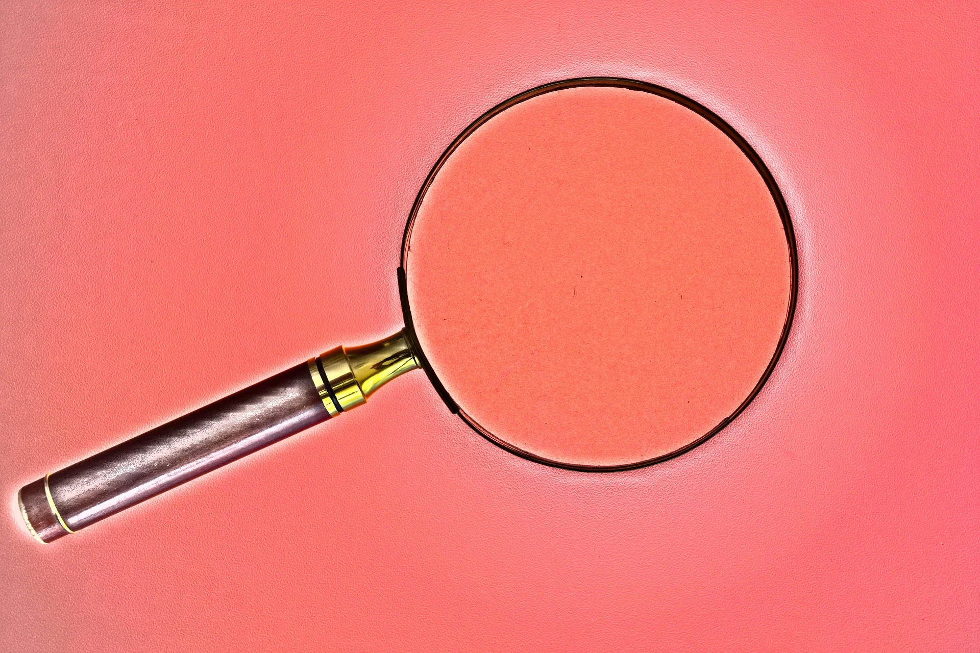 Magnifying glass on red background